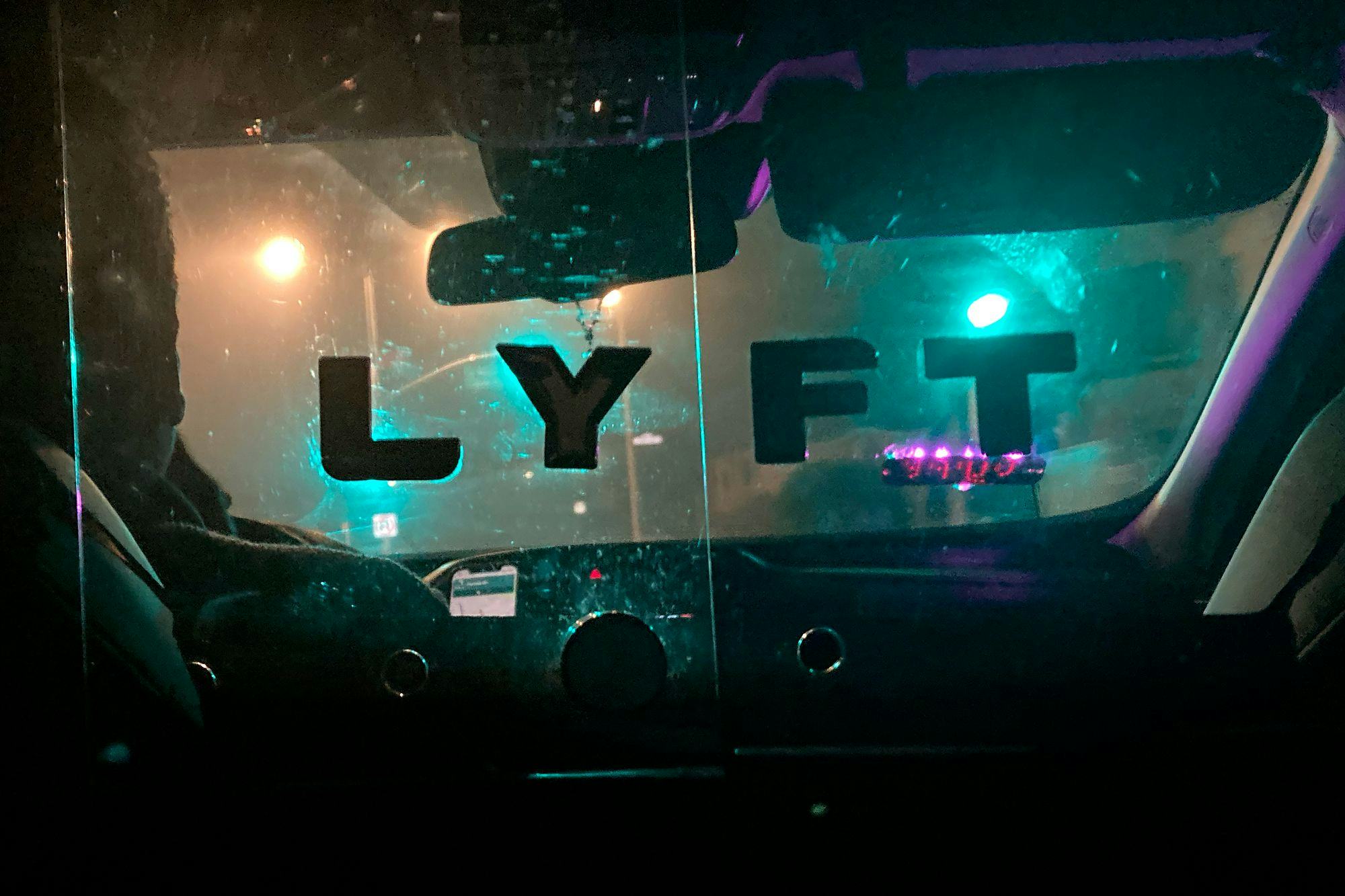 A Lyft sign is displayed in a driver's car in San Francisco.