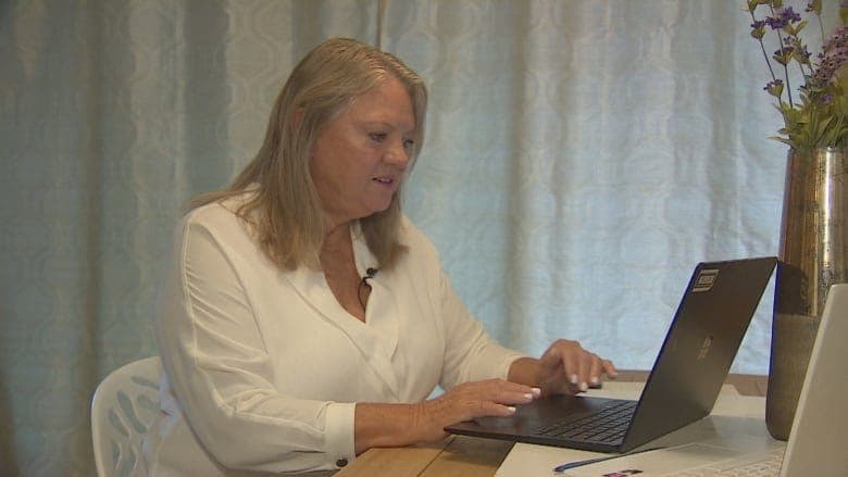 District councillor Catherine Pope looks at a laptop.