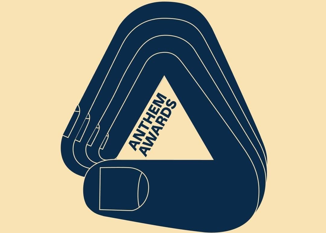 Logo for the Anthem Awards is shown in navy against a pale yellow background.