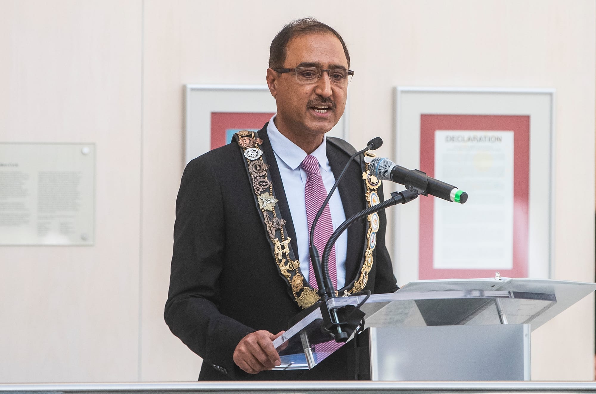 Edmonton Mayor Amarjeet Sohi is seen standing at a podium during a swearingin ceremony.