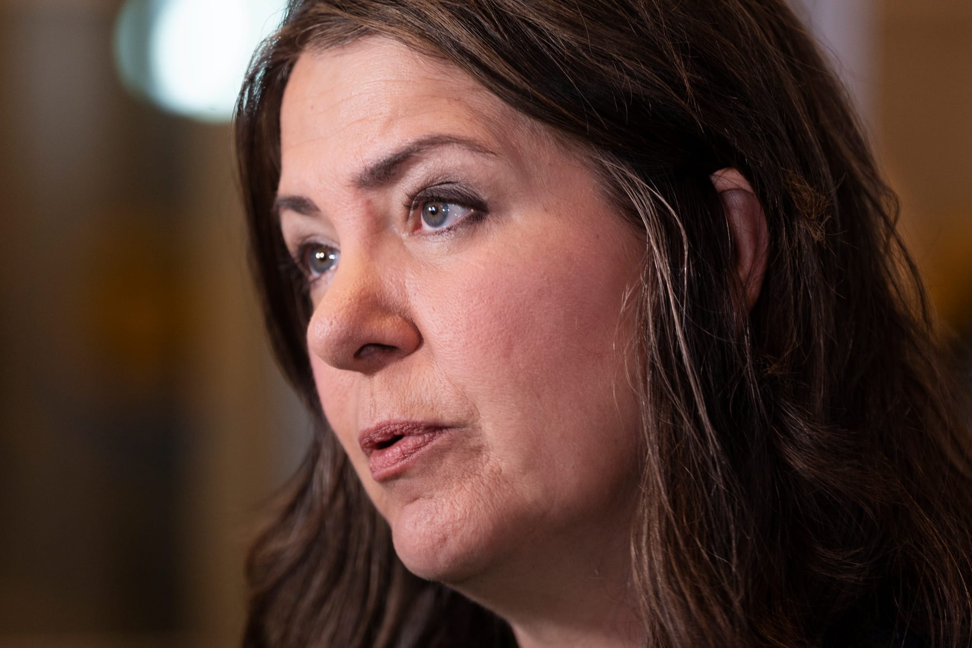 A close up of Alberta Premier Danielle Smith speaking with reporters during a press conference.