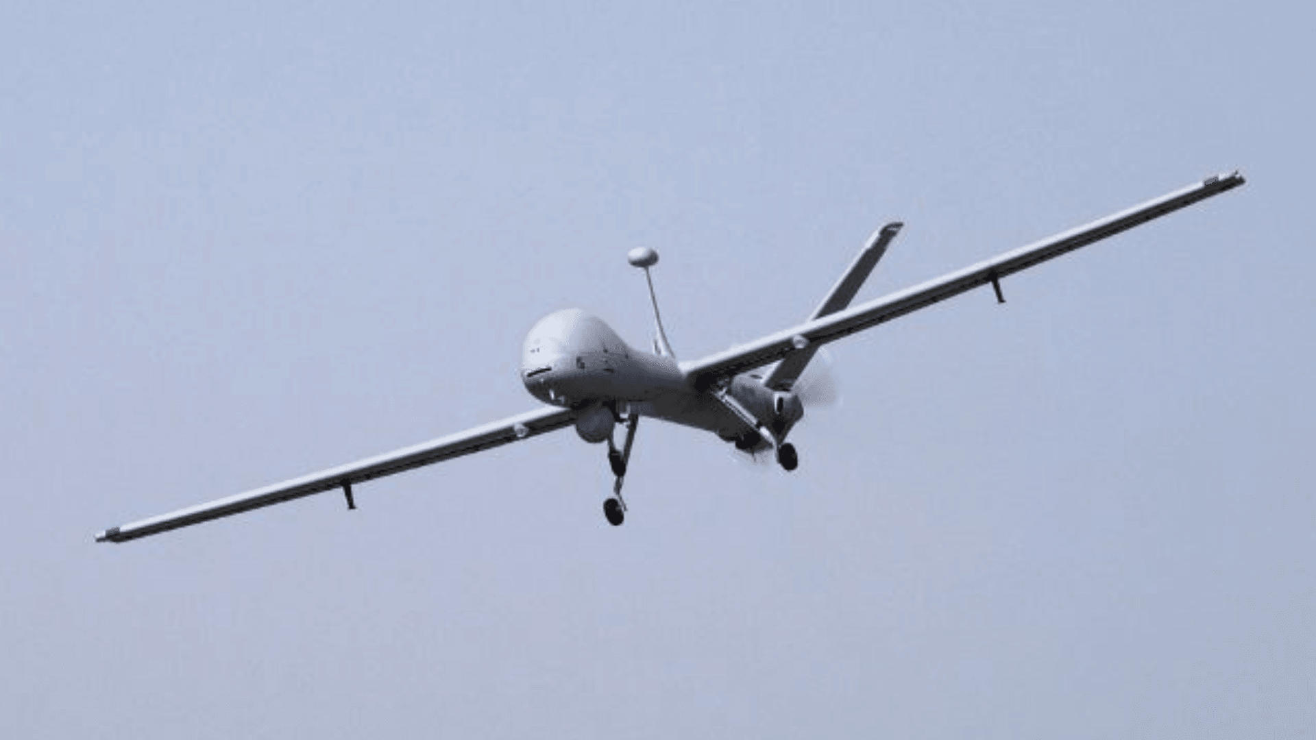 A winged drone flies through the sky