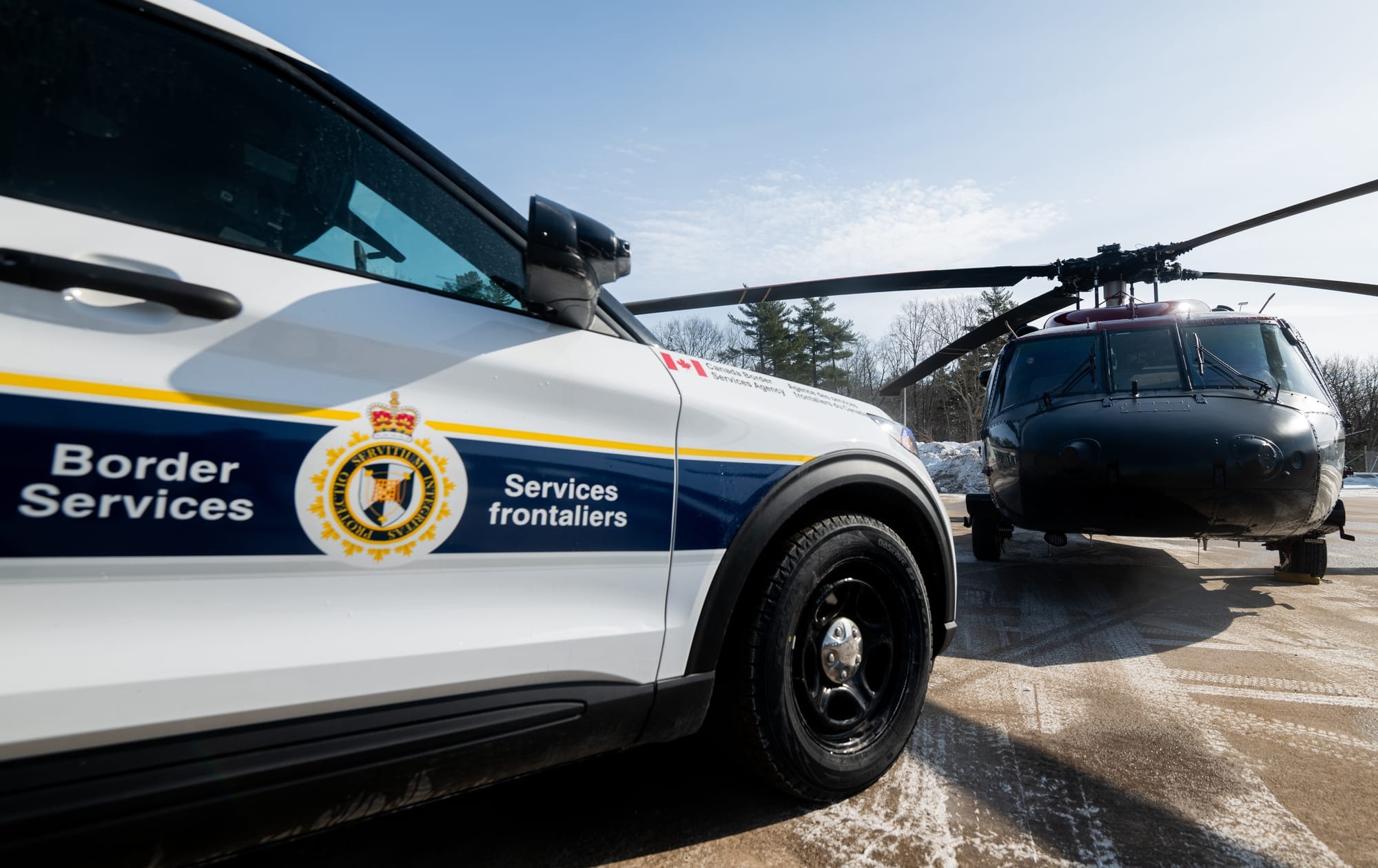 A CBSA patrol car and helicopt 