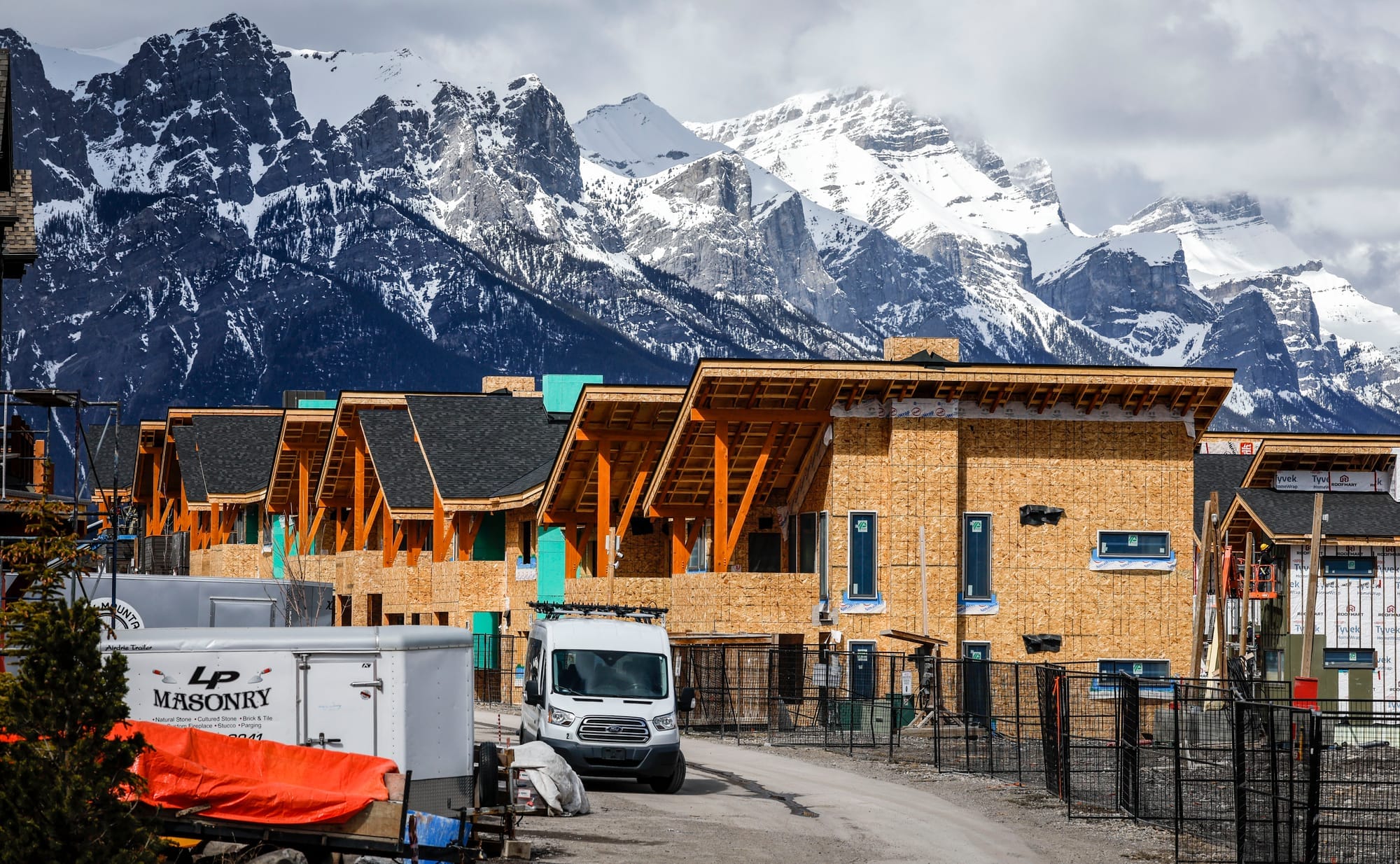 Homes are being constructed in front of a large mountain range