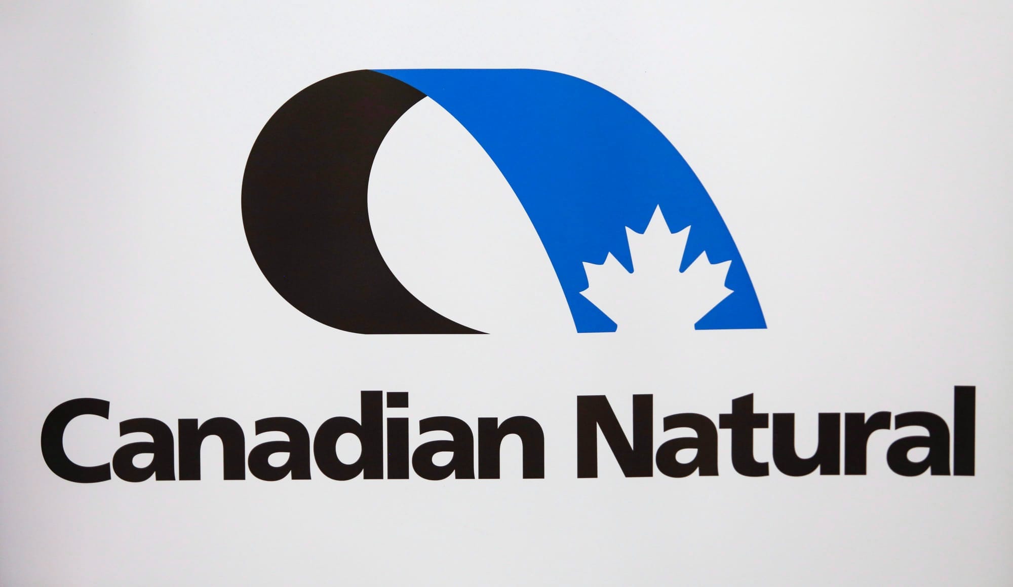 The words Canadian Natural and a blue and black logo against a white background.