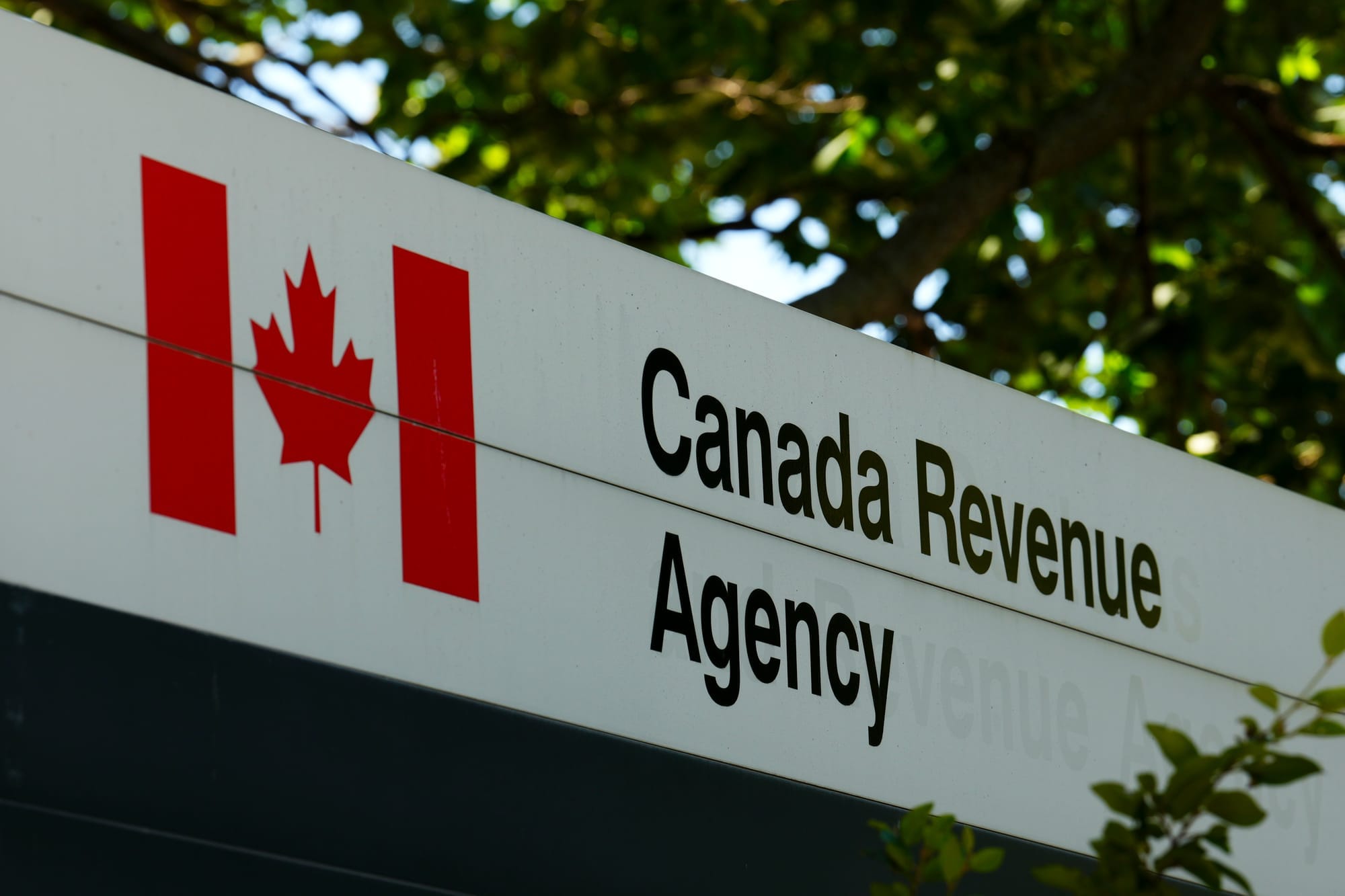 A sign bears a Canadian flag and says "Canada Revenue Agency" 