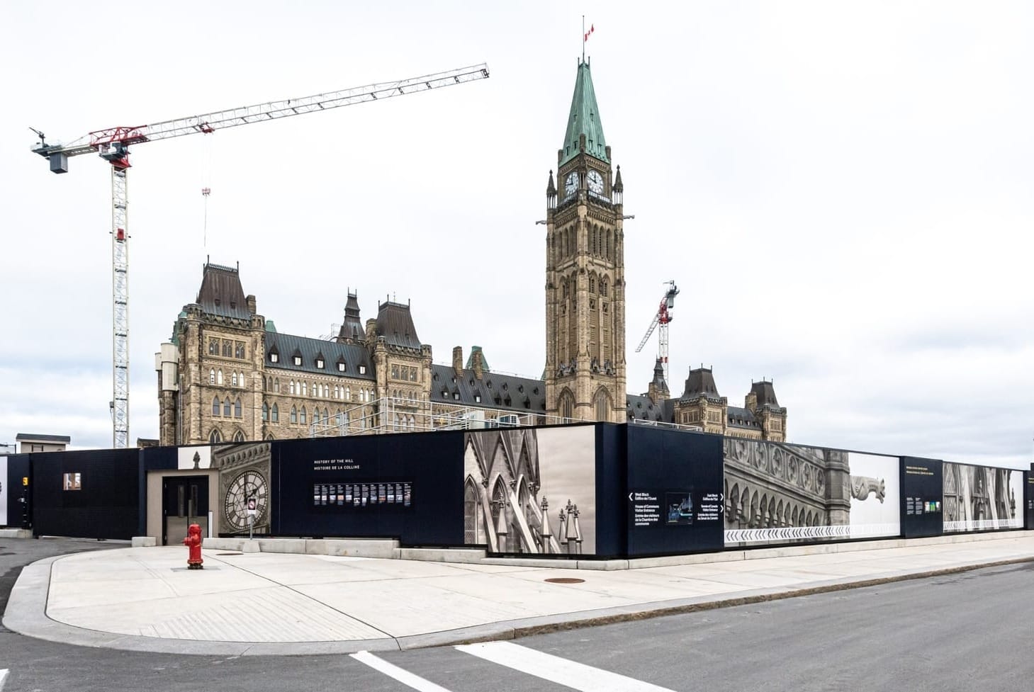 Parliament Hill's Centre Block is shown under construction on a cloudy day.