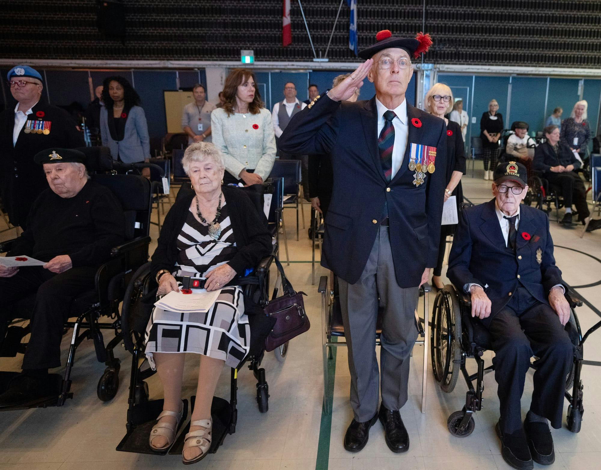 Several veterans in formal attire wearing poppies.